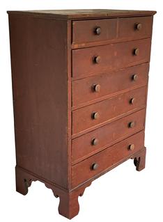 X249  Early 19th century seven drawer tall chest in the original dry red paint, resting on tall applied bracket base. The wood is pine, the drawers are square nail construction, solid ends  circa 1820