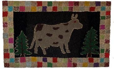 F127 Since the first half of the 19th century, rug hooking has been a popular craft in America, likely sprung from communities in Maine and the Canadian Maritimes. Hooked rugs were made from scraps of fabric and yarn to serve as functional floor pieces and as decorative embellishments for the home. This is a beautiful hand Hooked Rug of a folky cow standing between two trees, on a black background with a checker board of many colors.