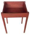 K32 Late 19th century Country Store display bin bearing old red painted surface. The bin has an open well area with tapered sides and rests on tall pencil post legs. Measurements: 23 ¾” wide x 20” deep x 32 ½” tall (back) x 29 ¼” tall (front).