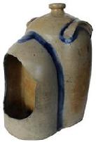 D154 Decorated Stoneware Chicken Waterer, circa 1850, straight-sided form with rounded top and tall finial, with attached handles and open, hooded watering section.This example was probably made at the Remmey Pottery