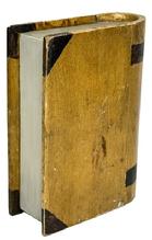 **SOLD** M324 Unique carved wooden book shaped box with hinged Cover/Lid retaining its original mustard and brown painted surface. This book is made to appear all the more realistic with its rounded binding with added paint accents to look like title bands and recessed / painted pages. Natural patina interior of the box Is lined with a newspaper article from The Locomotive Engineers Journal for October, 1927. Measurements: 7 wide x 2 ¾ thick x 9 ½ tall.