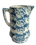 L333 19th century blue and white Spongeware pitcher boasting the classic sponge-applied blue semi-banded speckled pattern on durable stoneware. A banded embossed/impression of double diamond patterns encircles the bulbous base. Handle and spout are in good condition. Small hairlines throughout, but do not affect the integrity of this piece. Measurements: The footed base measures 4 ¾ diameter. Overall height is ~9 tall.