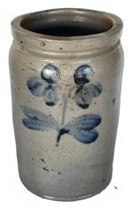 K1800 19th century Stoneware Jar stamped I - boasting Cobalt Clover / Floral decoration typical of Peter Hermann of Baltimore, MD. Tall, cylindrical jar with lipped rim and tooled shoulder with a cobalt clover on both the front and back. Good condition. Measurements: 6 top diameter x 6-6 ¼ bottom diameter x 10 tall.