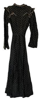(i315) Late 19th century Womans black and white dress with lined bodice and pressed leather buttons. This dress features decorative ruffles and woven cotton trim typical of the period. Very nice condition. Circa 1880s-1910.