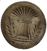 E21 19th Century very deeply carved wooden butter stamp with a large Sheaf of Wheat, 2 branches with leaves and a Pie Crust Rim. NOTE: In early Christian paintings, a single sheaf of wheat represents harvest and fertility. Measurements: 4 1/4" Diameter x 3” tall