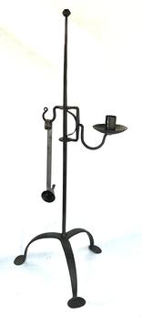 **SOLD** K1815 Tall adjustable iron candle holder resting on arched, tripod legs ending in padded feet. The top of one leg is stamped JM  for the maker, Jerry Martin. Hand forged iron lamp features a scalloped edged candle socket and drip cup. Lamp comes with an expertly handmade tin candle snuffer  also stamped JM. Measurements:  10 across feet x 26 ½ tall.  