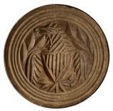 K1649 19th century tall, handled chip-carved butter print stamp of Pennsylvania origin depicting an Eagle with shield and arrows. Incised rings encircle the outer edges. Carved from a single piece of wood. Natural patina surface. Measurements: 3 5/8 diameter x 2 ½ tall