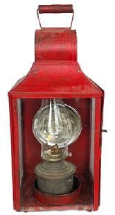 **SOLD** K1658 19th century large glass and tin Lantern with smoke ventilator chimney, large round reflector and clear glass hinged door for access to the fuel chamber inside. Decorative circles are punched through the tin in the bottom for air flow purposes. Lantern bears multiple layers of old red paint over its original red painted surface. Sturdy wire bail handle on top for carrying and original wire brackets on back for mounting to a wall or post. Measurements: 9� x 9� square x 20 &frac34;� tall (with handle up).  