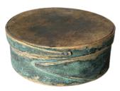 F27 19th century small painted finger lapped-seam pantry box bearing remnants of its robin egg blue painted surface.  American, round form with pine top and bottom and bent maple sides joined with opposing lapped fingers. Measurements are 7" diameter x 2 ¾ tall. 