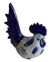 M113B Stoneware Pottery Rooster - with cobalt blue accents signed Eldreth and dated 2000 on bottom. Tiny chip to top. Approximate measurements: 6 ½ long x ~3 ½ wide x ~7 ¼ tall.