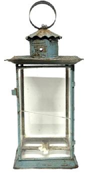 M1112 19th century large candle Lantern bearing original old blue painted surface. Lantern is glass and tin construction with a hinged door, smoke ventilator chimney bearing a crimped cover and round tin handle with folded edges attached to top with heavy wire. The thick pane of glass in the door has an early break that does not affect the integrity of the lantern. This lantern is unique in that it also has a glass bottom. The internal candle socket is supported via a tin band with rolled edges that is soldered to the frame. Measurements: 9 x 9 x 20¾ tall to top of handle.