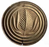 X265 19th century Chip-carved butter print of Pennsylvania origin, Butter Print has a very nice, deeply carved flower design. There is a small age crack from wood shrinkage. Measurements: 3 7/8 diameter x 2 ¼ tall