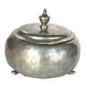 L266B Early lidded pewter pot. Hand hammered surface with soldered footed base and decorative finial on lid. Unmarked. Approximate measurements: 8 ¼” diameter x 6 ½” tall including finial.
