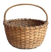 M157 Basket featuring its natural surface with a single wrapped, double rim and a steamed and bent handle that is woven into the basket. Nice, tight weave, with an interior bumped up bottom to help with weight distribution.