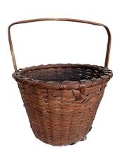 A308 Nice, 19th century Pennsylvania hand-woven footed Oak Splint Basket featuring tapered sides resting on slightly footed base. The tall, sturdy, steamed and bent handle is notched and woven into the sides. Sturdy single wrapped, double rim Great natural patina surface.