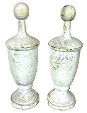 K1768 Pair of small size solid wooden architectural finials bearing several layers of white paint. Found in Pennsylvania. Each finial measures 3 ½ bottom diameter x 11 ½ tall.