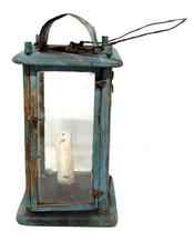 **SOLD** M251 19th century original blue painted wooden Lantern featuring four bubbled glass panels contained within a wooden pinned and post construction frame. The wood is pine. The door to access the interior candle socket is attached with tiny wire loop hinges and secured with a tiny wire loop that turns to open the door. There is a hole in the top for ventilation purposes which is covered on the exterior with a curved piece of sheet metal to create a hood that protects the candle flame from wind/rain. A wire bale handle is attached to the top for carrying/hanging purposes. Circa mid-1800s. Measurements: 5 square x ~9 ¾ tall not including handle.
