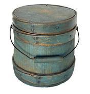 **SOLD** L500 Small 19th century New England firkin bearing original blue painted surface. Thick walled staved and bentwood construction with wire bail swing handle with wooden handle grip. Overlapping finger on all three wooden bands are secured with small copper tacks and a tiny copper wire staple at the tips. Natural patina interior. Measurements: 6 ¾ diameter (Bottom) x 6 ¼ diameter (top) x 6 ½ tall.