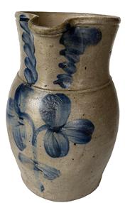 F159 One Gallon Cobalt Decorated Stoneware Pitcher, stamped “P. Herrmann”. (Peter Herrmann / Baltimore Potter /1825- 1901) Ovoid-bodied pitcher with tooled rim and applied strap handle decorated with a double clover and tri-leaf swags around the neck. Brushed cobalt swags decorate each side of the spout. Baltimore, Maryland origin. Measures 10” tall.