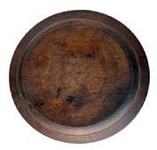 RM1610 Wooden treenware plate bearing very scant remnants of an incised ring on outer edge and slightly raised, hand hewn footed base bearing the initials "LS" carved into the bottom. Exceptional wear, chop marks and patina created by time and extensive use. Slightly out of round, measuring 7 x 7¼ diameter x ~ ¼ thick.