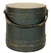 H967 Original Windsor green painted lidded firkin with tongue and groove softwood staved sides secured with tapered lap joint wood bands held in place with copper tacks. Remnants of maker's stamp visible on top of lid. Wooden swing handle attached by large buttonhead wooden pins. Very clean, natural patina interior. Measurements: 12 1/2" diameter (bottom) x 11 3/4" diameter (top) x 12" tall.