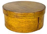 **SOLD** L225 New England round pantry box in old mustard painted surface over the original red paint. Steamed and bentwood construction secured with tacks and tiny wooden pins. Clean, natural patina on the inside. Measurements: 7 ½ diameter x 3 3/8" tall.
