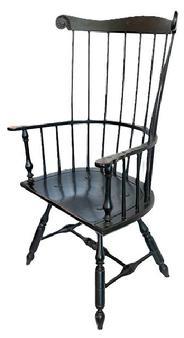 L217 Philadelphia-style bench made Comb-Back Windsor Armchair in original black painted surface. This sturdy bench made Windsor features a tall, stately back with nine straight spindles topped with a crest rail boasting carved ears and rests on graceful turnings on the stretcher and legs which are mortised through the broad, D-shaped seat. Measurements: 28 across front of arms x 17 ½ deep seat x 46 tall back. The seat measures 18 ¼ tall from floor.