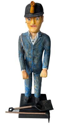 L27 Fantastic Folk Art wooden carving of a Coal Miner with Tools. Hand carved and painted with great details throughout. The Miner�s accoutrements include a helmet/hat with lamp, boots, canteen, pickaxe, coal shovel and very detailed clothing including metal buttons constructed of square head nails. Solid wood. Unsigned. Wooden base is 8� square. Overall height is 25 &frac34;� tall. Coal shovel measures 3 &frac14;� wide x 11 &frac34;� long. Pickaxe measures 5� wide x 11 &frac14;� long.  