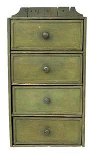 L195 19th century Pennsylvania hanging set of four drawers bearing its green painted surface. Drawers have molded edges. Small wire nail construction with original knobs. The wood is pine. Circa 1870s. Measurements: 12 wide x 5 ¾ deep x 23 ¾ tall (back).