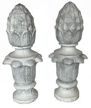 **SOLD** K9 Very early 20th century pair of matching solid cast iron Pineapple finials with geometric diamond shaped details on top with a series of detailed curved leaves below. Surface retains several layers of old white paint. Each finial is impressed with a marking that reads: 108 J. Hole inside the bottom for mounting purposes. Extremely heavy.  Circa 1900-1920s. Approximate measurements: 8 diameter (at widest point) x 5 ¾ diameter (at bottom)