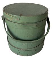 M618 19th century, medium sized firkin or sugar bucket in original dry green paint. It has a wooden swing handle attached by large buttonhead wooden pins. Old nails or tacks hold the lap bands in place. In great condition with nice patina. measurements are (' across the top x 9 1/2" tall x 9 1/2" diameter bottom