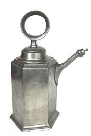 L268A Large six-sided pewter wine container with threaded lid with ring for carrying, and threaded spout cover. Engraved “HC.SHB” on side and bears maker’s stamp on bottom “R-B”. Very heavy. This is a typical style of wine vessel used in the 18th century and was also known as a “Prismenkanne” or “Zinnkanne”. Approximate measurements: ~7 ¾” across widest point on bottom x ~11” deep to tip of finial on spout lid x ~15 ½” tall including ring on lid.