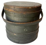 G821 19th century Original dark green painted firkin with staved sides and steamed and bent handle secured with wooden pegs. The finger lapped bands are secured with tacks and one tiny staple at the very tip of each band. Very sturdy. Great natural patina inside. Wear indicative of age.