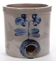 E242 BALTIMORE, MARYLAND DECORATED STONEWAREDIMINUTIVE WATER COOLER, salt-glazed, approximately one-gallon capacity, cylindrical form with single incised ring and squared rim. Brushed cobalt upright double-blossom floral decoration on both sides, additional cobalt encircling bunghole. Probably the pottery of Peter Herrmann (1825-1901), Baltimore, MD. Second half 19th century. 7 3/4" H, 8" D rim.