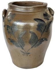 K1683 19th century Cobalt blue decorated four-gallon Stoneware Crock with applied lug handles. Ovoid jar with cobalt floral decoration on the front and reverse. A stamped 4 inside a circle is visible by one of the handles. Measurements: 8 x 8 ¼ top opening x 14 ½ tall.