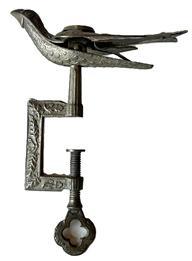 K1705 19th century American Sewing Bird Clamp with original surface boasting prominent stamping that reads Patented on the birds right wing, and Feb 15, 1853 on birds left wing. All mechanics are in good working condition and the beak clamps tightly. This is a great example of the first sewing bird patent that was granted to Charles Waterman of Meriden, Connecticut on February 15, 1853 and was by far the most popular style often called the Waterman Bird after its creator. This style of highly decorated sewing bird was considered a status symbol indicating wealth. It was also a treasured token young men would give to their betrothed prior to their wedding as a reminder of her future husband while she prepared her wedding trousseau and sewed items for the future household. Approximate measurements: 3 ½ long (beak to tip of tail) x 2 wide x 5 tall.