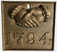 E396 A heavy cast iron fire mark with clasped hands and “1794” in relief in later gold gilt paint.