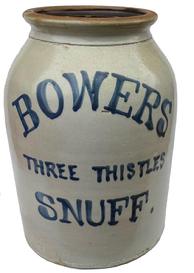 F157 19th century Pennsylvania early BOWERS THREE THISTLES SNUFF Advertising Stoneware Crock. Large four-gallon, off white salt glazed stoneware Crock with freehand cobalt painted label "Bowers Three Thistles Snuff" on front. It has straight sides and flared lip with brown glazed interior and cobalt painted inscription as above. It measures 14 1/4" tall and 9 1/2" bottom diameter