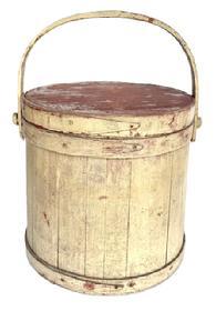 L249 19th century wooden firkin with staved sides and steamed and bent handle secured with wooden pegs bearing old pale mustard over original red painted surface. The finger lapped bands are secured with copper tacks. Very sturdy with great wear from years of use. Great natural patina inside. Measurements: 11 ½ top diameter x 12 ¼ bottom diameter x 11 ¾ tall.