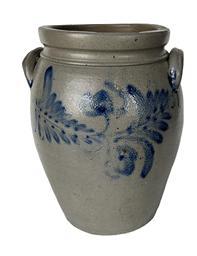K165 19th century cobalt blue decorated 2-Gallon Stoneware Crock attributed to Peter Hermann (1825-1901) of Baltimore, Maryland. Ovoid shape with tooled shoulder, grooved collar with squared rim and applied lug handles. Prominently stamped 2 beneath one of the handles. Fantastic hand brushed Cobalt flowers and leaves encircle the crock along the shoulder. Circa 1840s-1860s. Hairlines to bottom and minor chips along the rim. Measurements: 6 5/8 diameter (bottom) x 8 ½ diameter (top) x 12 tall