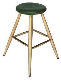 K328 Tall round splay legged wooden stool boasting the original green and white painted surface with excessive wear on the stretchers from many years of use. Very sturdy. Measurements: Top is 13 ¼ diameter x 1 ¾ thick. Overall height is 26 tall and it measures 20 wide across splayed feet.