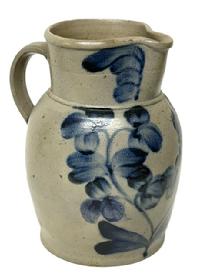 M163 Beautiful 19th century Baltimore, Maryland Peter Herman one gallon Crock Pitcher stamped I just below the spout. This stunning stoneware pitcher was made in Baltimore circa 1850 1870s. It is decorated in cobalt with a two-stemmed flowering plant, along with flowers on the rim and highlights at the handle terminals. Approximate measurements: 6 diameter (bottom) x 10 tall.