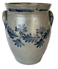 **SOLD** K164 19th century cobalt blue decorated Stoneware Crock attributed to Remmey of Philadelphia, PA. Ovoid shape with tooled shoulder, decorated flared collar with squared rim and applied lug handles. Fantastic hand brushed Cobalt fan-shaped flowers and leaves encircle the crock along the shoulder. Circa 1840s-1860s. Hairlines to bottom. Measurements: 6 5/8 diameter (bottom) x 8 ½ diameter (top) x 12 tall