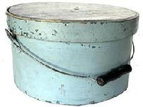 J413 19th century Pennsylvania bail handle Pantry Box with lid. Light blue painted surface over the original darker blue paint. Steamed and over lapping bentwood sides are secured with small metal tacks. The sides of the pantry box are fitted with a pair of metal handle mounts securing an arched wire swing handle with wooden hand grip. Heavy construction with tightly fitting lid. Measurements: 11 ¾ diameter (top) x 11 ½ diameter (bottom) x 6 ¼ tall