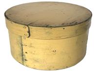 K1874 19th century New England pantry box in wonderful pale-yellow paint over the original blue-gray surface. The steamed and bentwood constructed overlapping sides and rim of lid are secured with small tacks. Great natural patina inside. Measurements: 8 ½ diameter (bottom) x 8 ¾ diameter (top) x 4 ¼ tall.