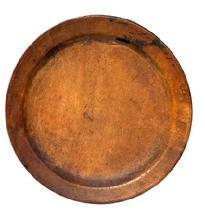 L407A Early wooden plate - with initials and symbols carved into the bottom. Nice patina and wear indicative of use. Out of round. Measurements: 7 3/8" x 7 ¾ diameter x ½ deep.