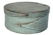 K1873 19th century New England pantry box in original dry, gray paint with opposing single finger laps on both body and lid. Steamed and bentwood sides and rim are secured to top and bottom of box with tiny wooden pegs and miniature tacks. Dark patina on interior consistent with age and use. Measurements: 7 7/8" diameter (top) x 3 ¼ tall.