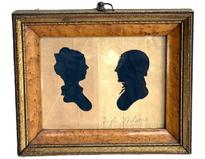 **SOLD** M211 Exceptional 18th century identified Pennsylvania framed hollow-cut silhouettes of a woman and a man facing each other against a black background. The name Hugh Wilson is written in pencil below the man. The birds eye maple frame with gold gild accents and an early ring intact on top for hanging purposes all appear to be original. In this type of silhouette, the profile was cut out and discarded. The remaining surrounding paper was then placed against black paper or silk fabric to prominently reveal the wonderful profile. Circa 1790 1810. Framed measurements: 7 5/8 wide x 1 thick x 6 3/8 tall.