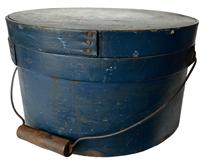 RM1077 19th century New England bail handle pantry box, The box retains the original lid and bail handle. Everything is sturdy and stable.The original beautiful blue paint Measurements: 11 1/4" diameter x 6 1/2" tall