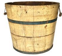 K1724 19th century Pennsylvania wooden bucket retaining original mustard grain painted surface with original blue painted metal bands securing the staved sides. Original bale handles remain intact on each side of the bucket. Measurements: 16 ¼ top diameter x 13 bottom diameter x 13 ½ tall.